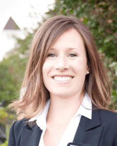 headshot of a smiling young caucasian teacher with shoulder length brown hair