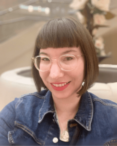 headshot of a smiling young female caucasian instructor with glasses and short, dark bobbed hair