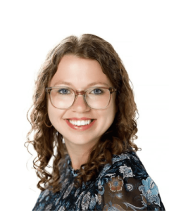 headshot of a smiling young femal caucasian psychologist with glasses and long wavy light brown hair